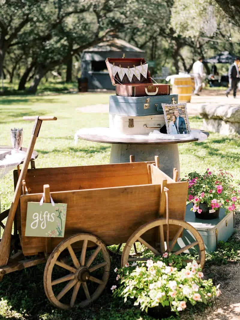 The gift wagon stacked with vintage suitcases and blooms