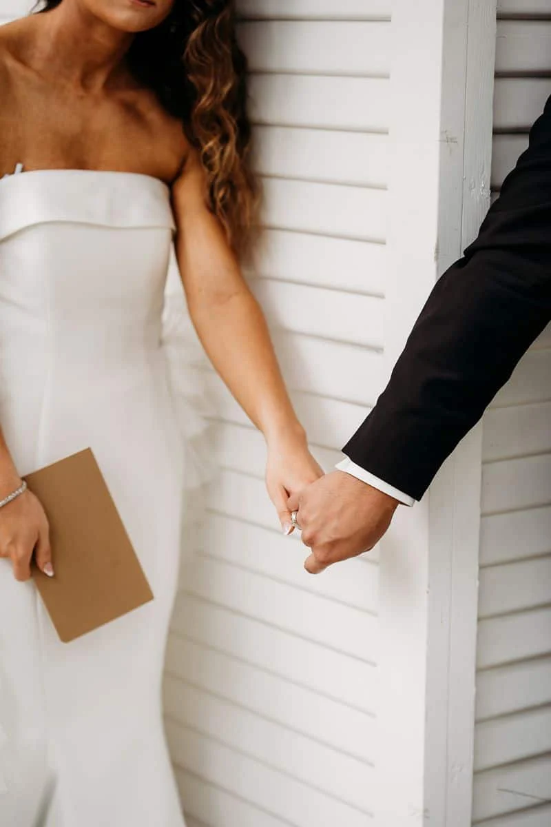 Mackenzie and Ronnie holding hands around the corner, unseen