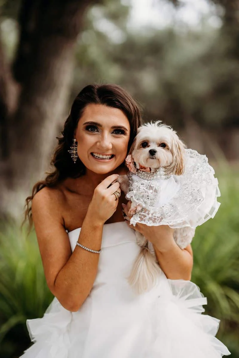 Mackenzie holding their dog at The Chandelier of Gruene in the Texas Hill Country