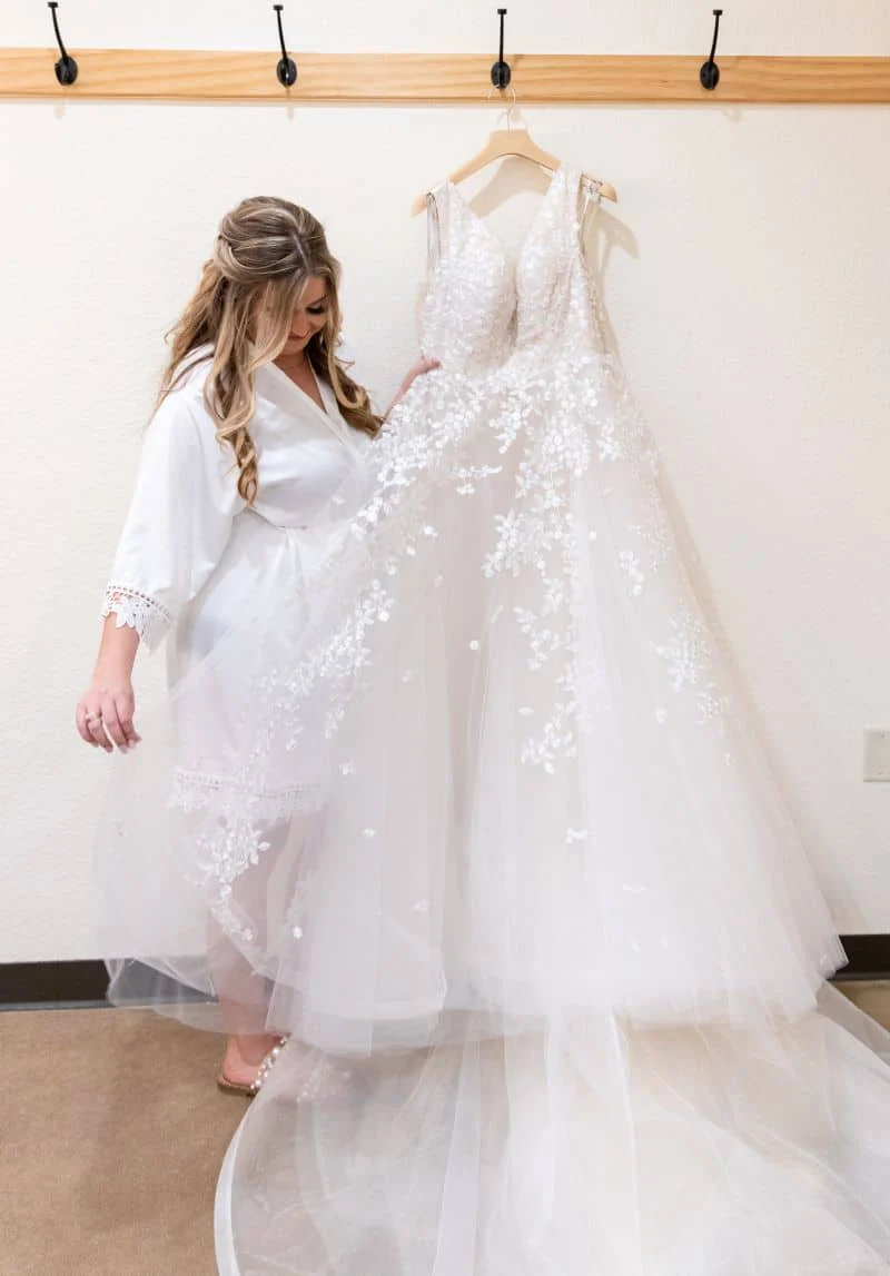 Frances standing beside her gown before putting it on