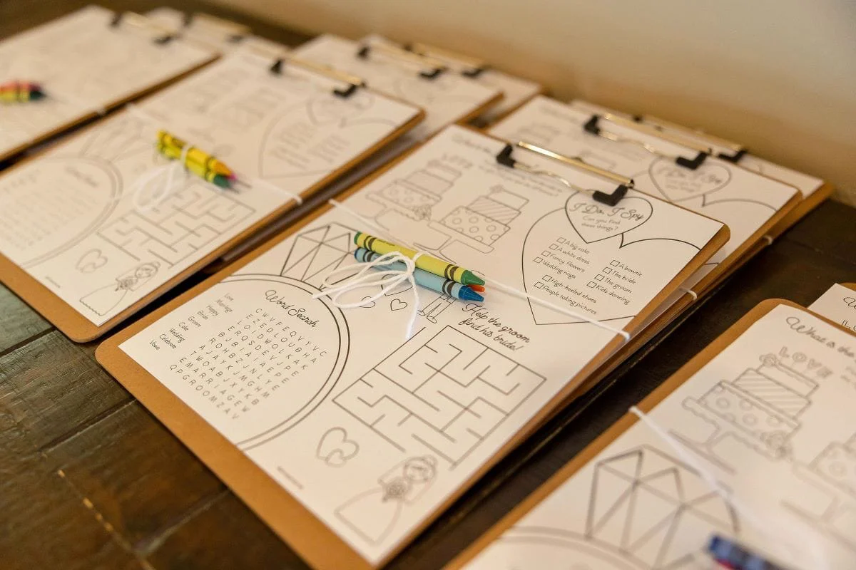 Activity clipboards and crayons set out for the younger guests