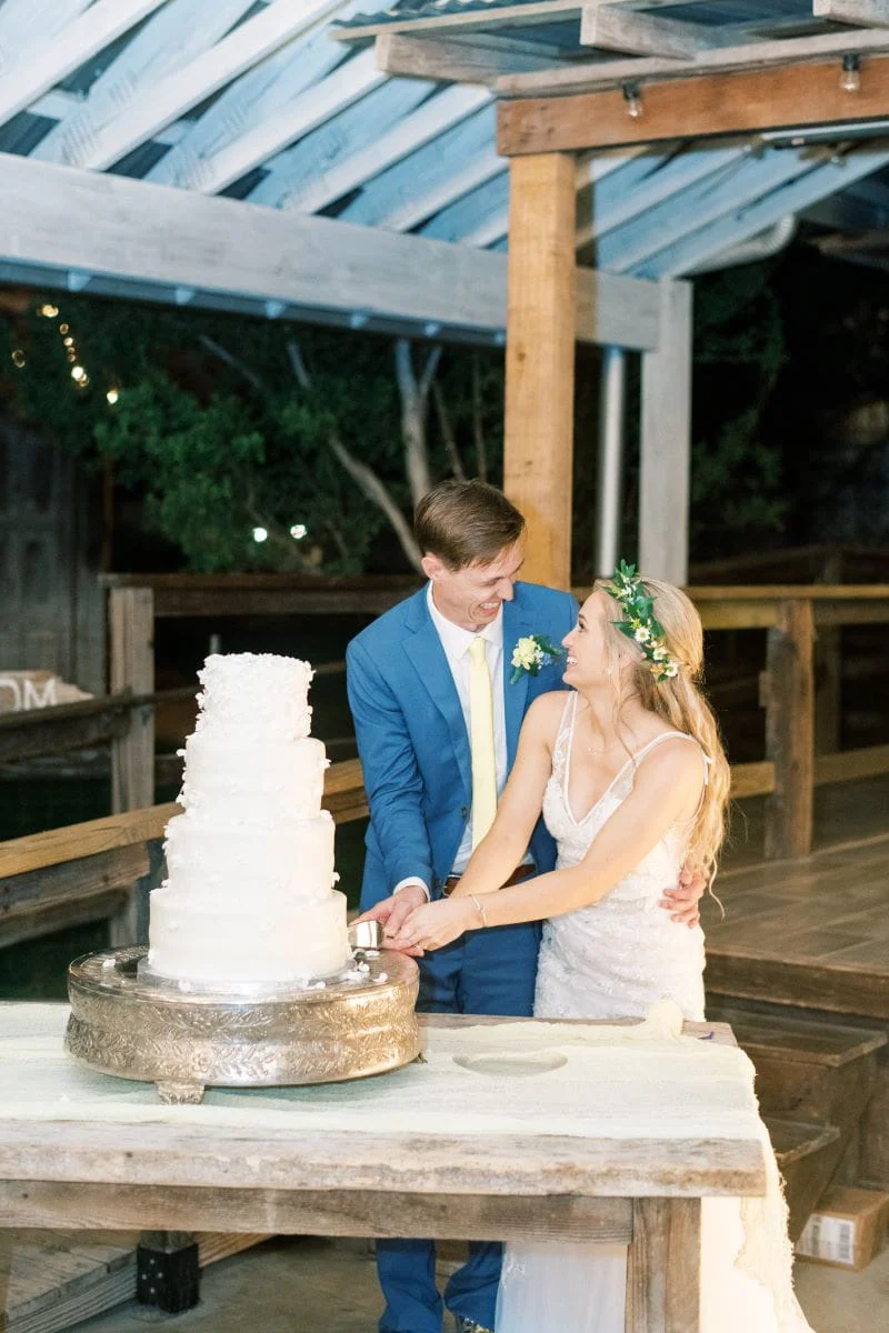 Cutting the four-tier Italian cream cake together at the reception