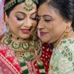 A bride and her mother posing after getting their Hill Country hair & makeup done