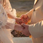 A bride and groom holding hands at their wedding ceremony