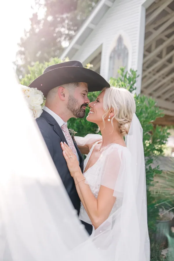 Colin and Shelby Stovall nose to nose outside the chapel at Gruene Estate in the Texas Hill Country