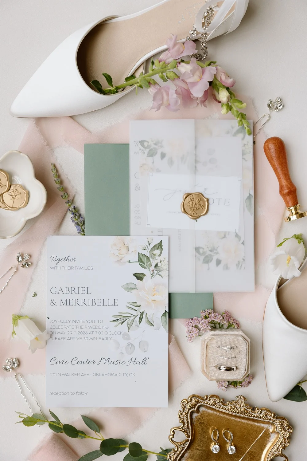 Wedding invitation suite with a gold wax seal, white heels and earrings for the Civic Center Music Hall wedding