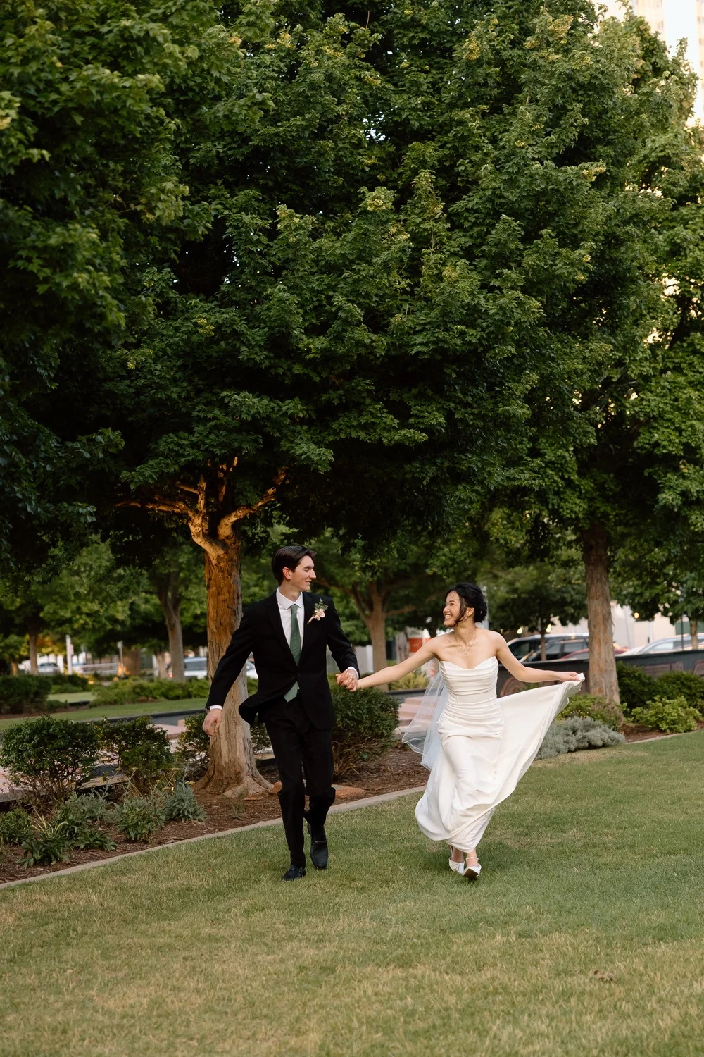 Gabriel and Merribelle dance together on the lawn beneath the trees