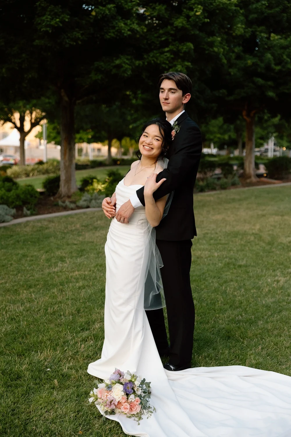 Gabriel and Merribelle outside the venue with her bridal bouquet