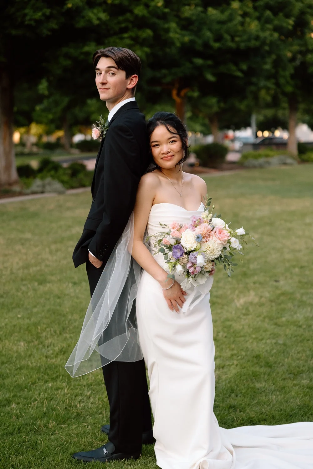 The newlyweds pose together on the lawn after their Oklahoma City wedding