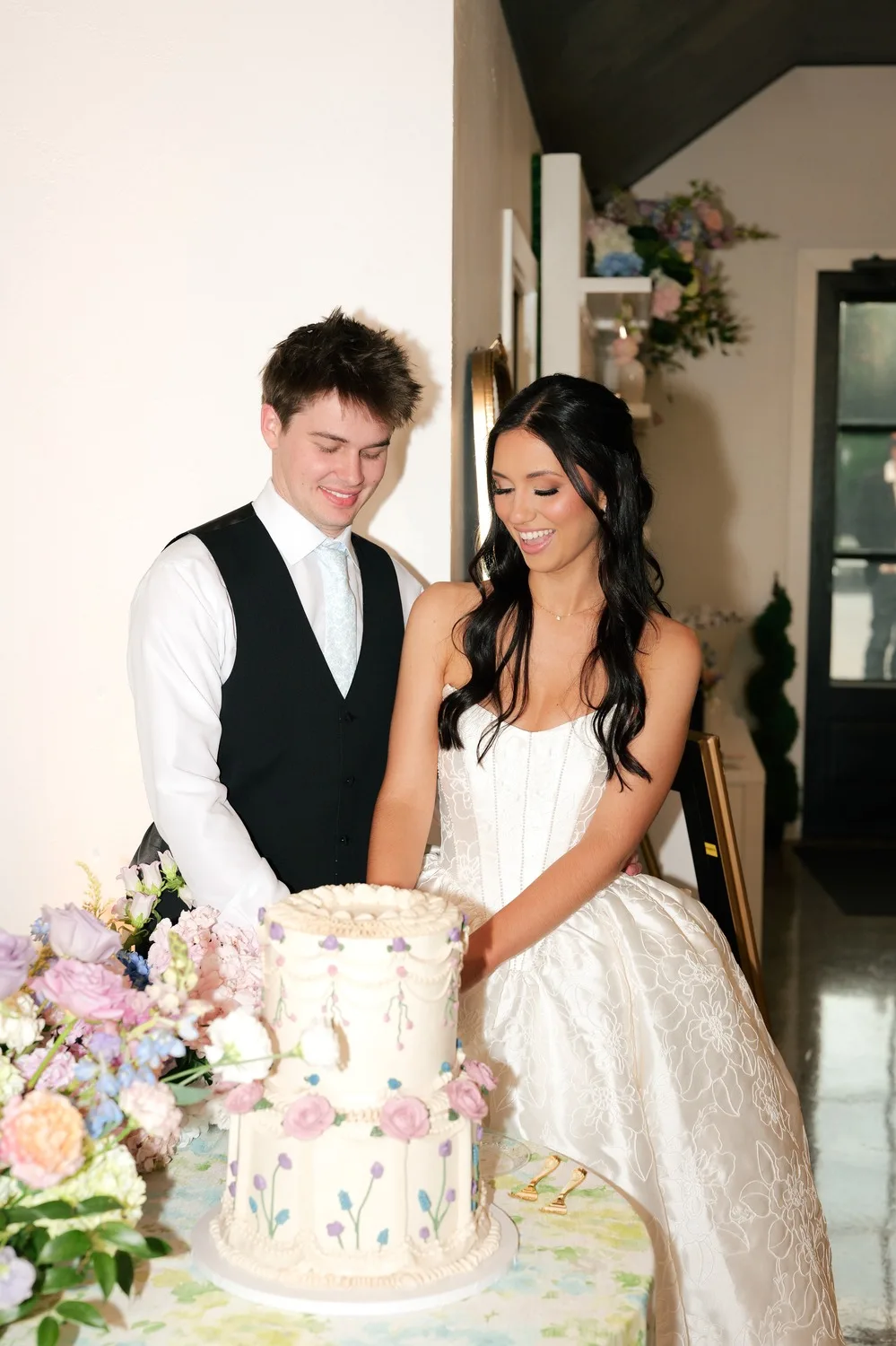 The newlyweds cut their vintage-style wedding cake together at the reception