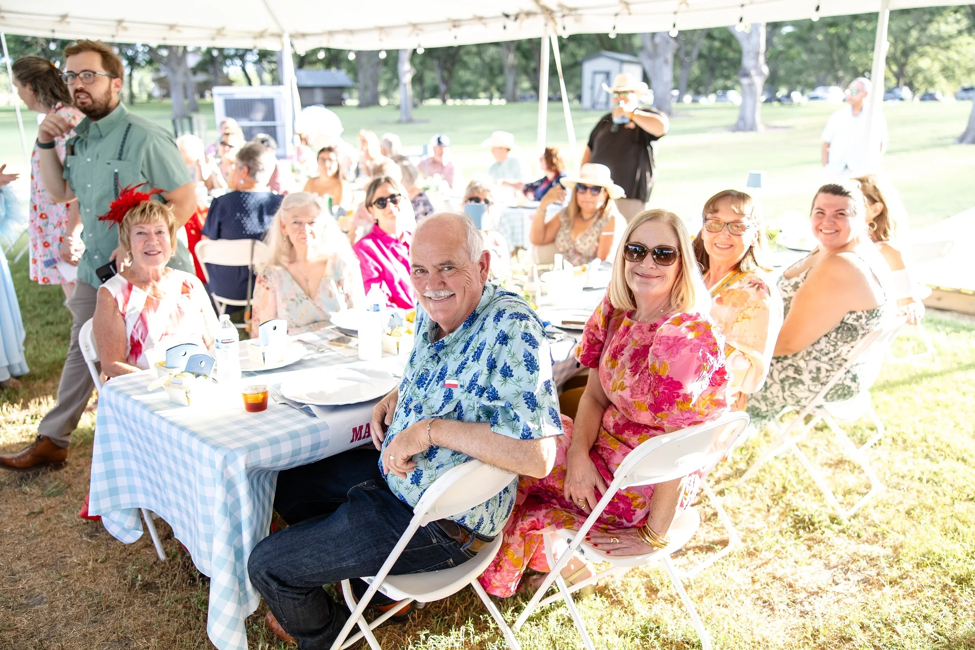 Wedding guests seated under the reception tent at Santos Patronos Ranch