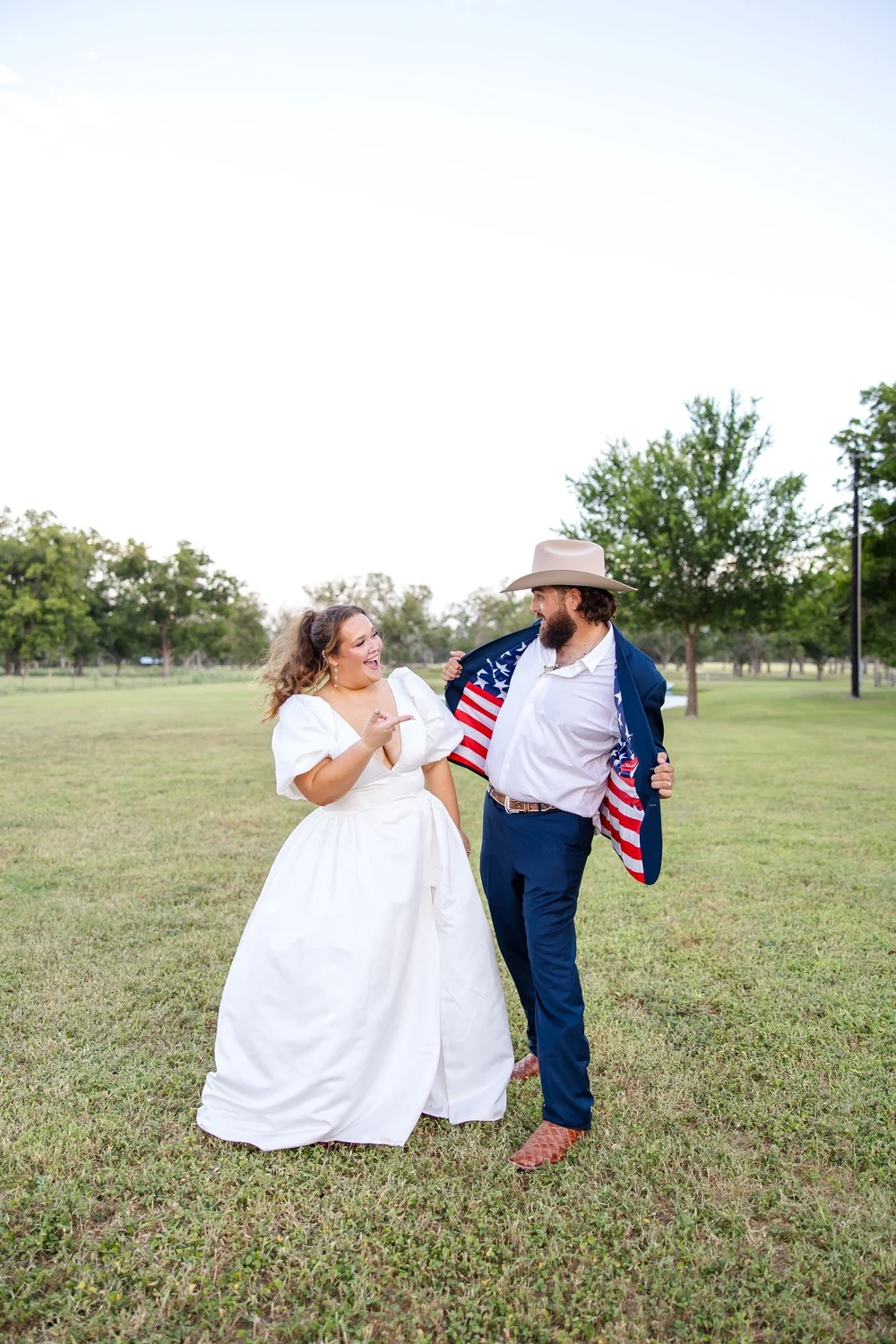 Kolby and Ryan Hensley with an American flag for their Fourth of July wedding
