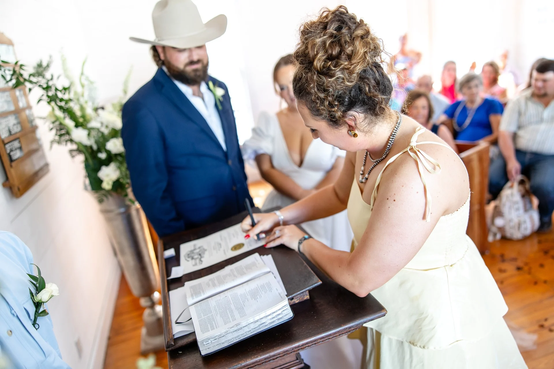 Signing the marriage license at the front of the church