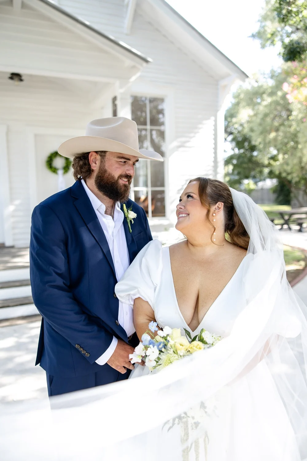 Kolby and Ryan Hensley outside the white chapel on their wedding day